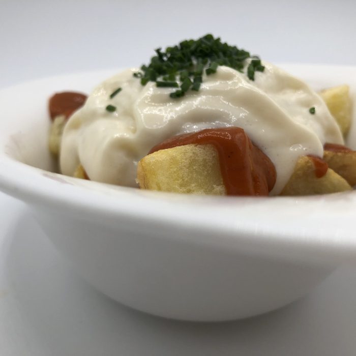 Patatas bravas de corte tradicional con salsa brava y espuma de alioli